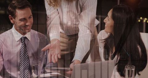 Business Professionals Analyzing Digital Charts on Tablet