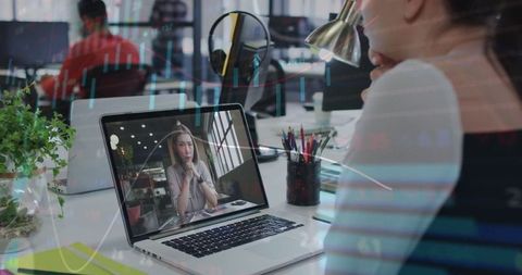 Woman Engaged in Virtual Meeting at Modern Workspace