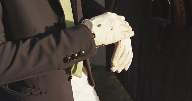 Equestrian Preparing Gloved Hands with Blazer and Light Green Tie - Download Free Stock Images Pikwizard.com