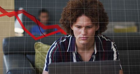 Businessman Analyzing Declining Market Trends on Laptop