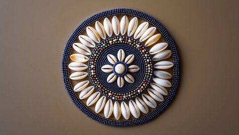 Artisanal Cowrie Shell and Bead Ornament on Brown Background
