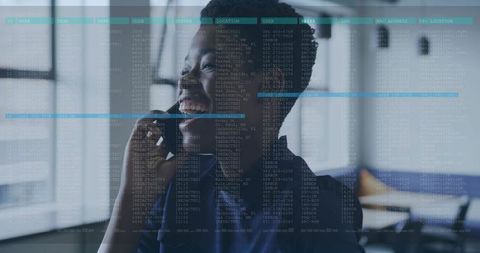 Smiling professional woman talking on phone with data overlay in modern corporate office