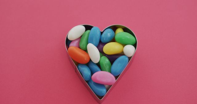 Multicolored Candy in Heart Shaped Container on Pink Background - Download Free Stock Images Pikwizard.com