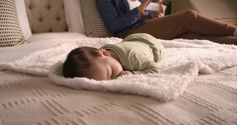 Relaxing moment with baby lying peacefully on cozy blanket