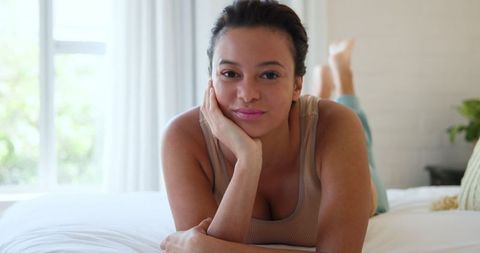 Woman Relaxing on Bed in Modern Minimalist Bedroom