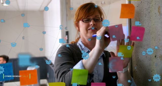 Professional woman brainstorming with colorful sticky notes on glass wall in office - Download Free Stock Images Pikwizard.com