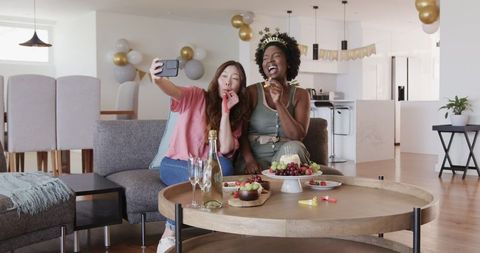 Interracial Lesbian Couple Celebrating Birthday at Home Party