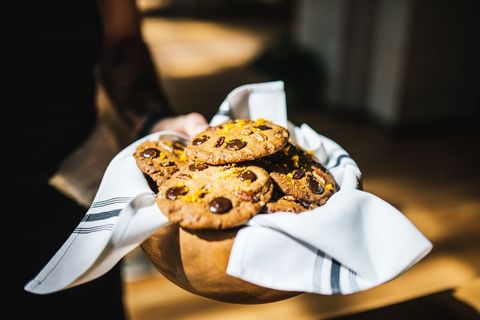 Freshly baked chocolate chip cookies in rustic basket