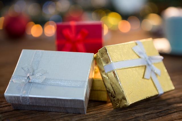 Wrapped gifts on wooden plank during christmas time
