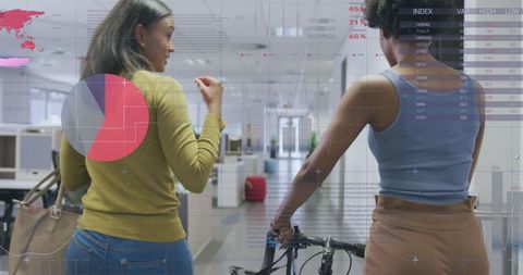 Businesswomen Analyzing Reports with Infographic Interface in Office