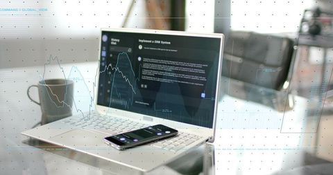 Minimalist office laptop showing crm dashboard and analytics with smartphone and coffee mug