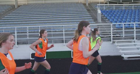 Female field hockey team training on outdoor field