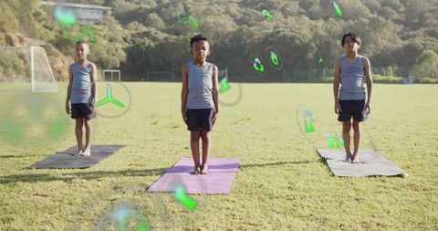 Boys Practicing Yoga Outdoor with Floating Digital Icons
