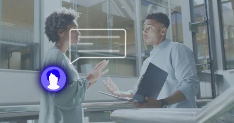 Colleagues discussing project in modern glass atrium with speech bubble avatar