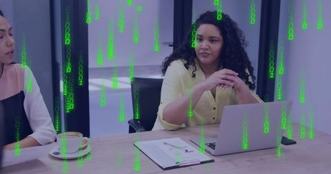 Business leader in yellow blouse leading digital boardroom meeting with binary overlay