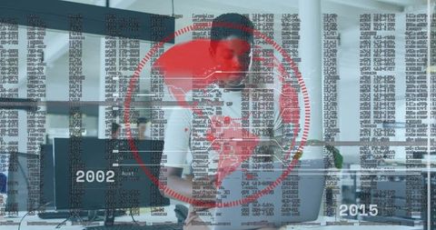 Businesswoman analyzing global data overlay, comparing laptop and phone in modern office