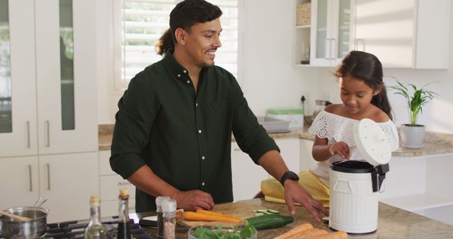 Hispanic parents and daughter cooking and teaching segregating bio trash - Download Free Stock Photos Pikwizard.com