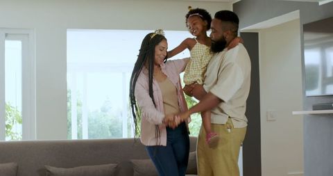 Happy Family Dancing Together Celebrating Birthday at Home