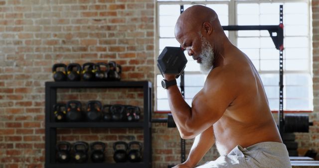 Senior Man Lifting Dumbbell in Industrial Gym Setting - Download Free Stock Images Pikwizard.com