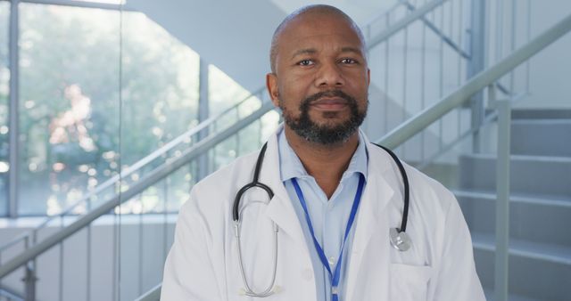 Confident Male Doctor in Hospital Hallway with Stethoscope - Download Free Stock Images Pikwizard.com