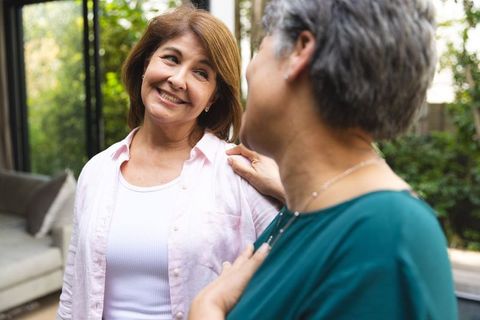 Senior Mother and Daughter Smiling Together in Warm Family Setting