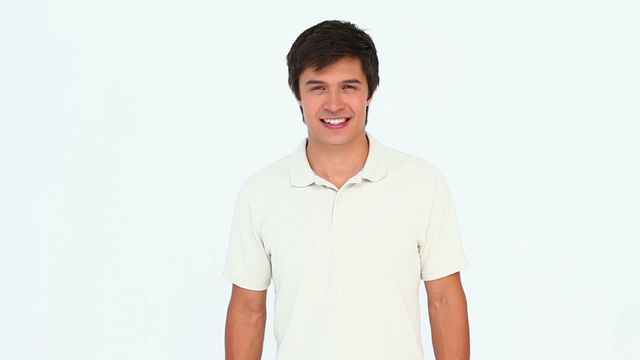 This image depicts a man wearing casual attire with a bright smile, showcasing dynamic movement with his head. Perfect for illustrating concepts of positivity, approachability, or happiness. Useful in advertising, lifestyle blogs, and promotional materials emphasizing energetic or friendly themes.