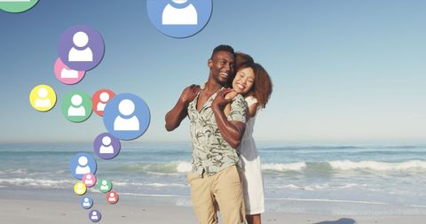 Joyful Couple Embracing on Sunny Beach with Social Media Symbols