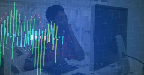 Office worker analyzing data on computer with interactive charts