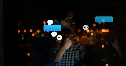 Professional man in office at night engaging with technology