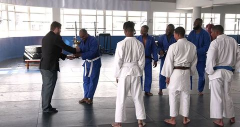 Martial arts trophy presentation at dojo celebrating achievement