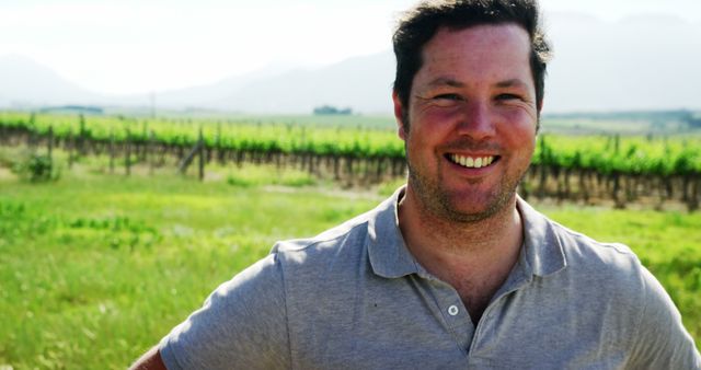 Smiling Farmer in Sunny Vineyard Wearing Gray Polo Shirt - Download Free Stock Images Pikwizard.com