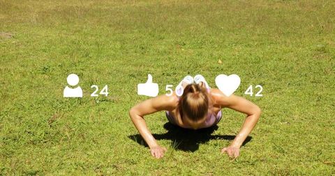 Fit woman doing push-ups on sunlit lawn with social media engagement icons