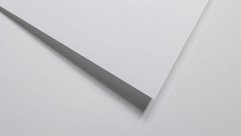 Minimal white paper forming sharp diagonal composition, casting soft geometric shadows