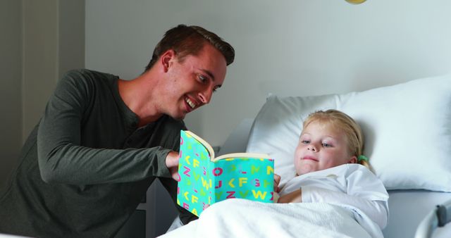 Male Reading Book to Sick Child in Hospital Bed - Download Free Stock Images Pikwizard.com