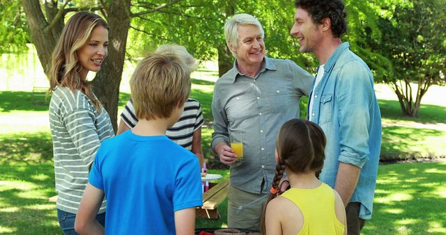 Multigenerational Family Enjoying Picnic in Park on Sunny Day - Download Free Stock Images Pikwizard.com