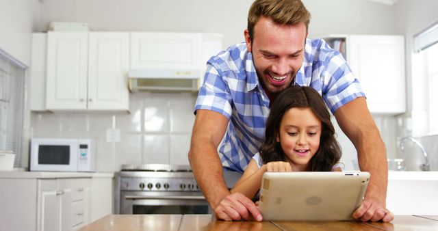 Father and Daughter Using Digital Tablet Together in Kitchen - Download Free Stock Images Pikwizard.com