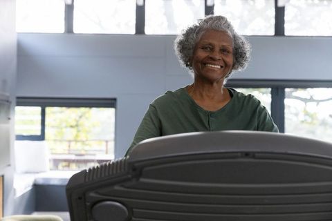Senior woman exercising on treadmill with positive attitude