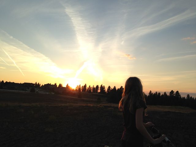 Girl on Bike Watching Beautiful Sunset in Rural Landscape - Download Free Stock Photos Pikwizard.com
