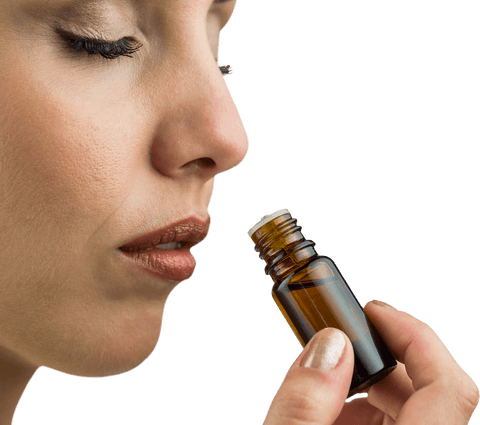 Transparent close-up woman smelling aromatherapy bottle