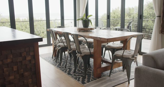 Cozy dining room with large windows and wooden table - Download Free Stock Images Pikwizard.com