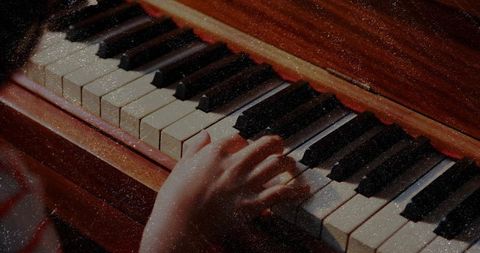 Child playing piano with concentration and skill