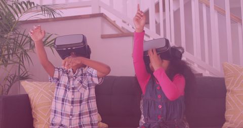 African American Siblings Enjoy Virtual Reality on Sofa Indoors