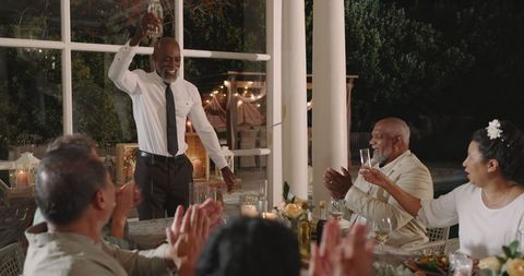 Elegant backyard wedding toast, diverse guests celebrating evening event