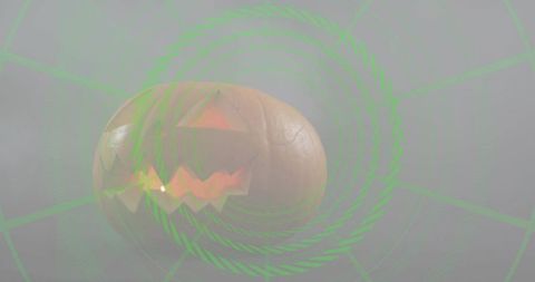 Glowing jack-o'-lantern floating in mist with neon green spiral overlay
