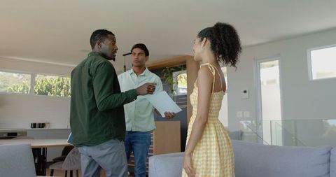 Couple consulting with advisor at home in modern living room