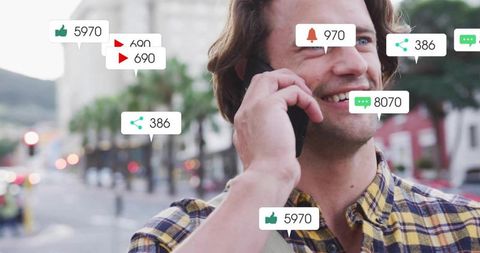 Smiling man holding smartphone on city street showing social media notifications and engagement