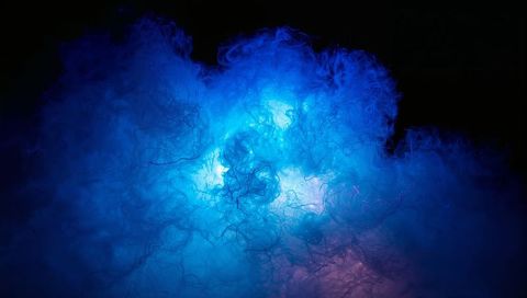 Swirling luminous blue smoke cloud with neon cyan backlight, wispy filaments, deep haze