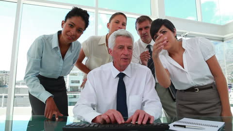 Diverse Business Team Collaborating with Senior Boss in Modern Office