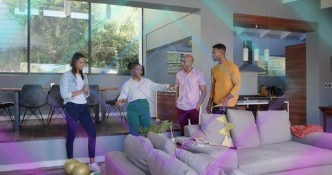 Friends chatting in bright modern open-plan living room with sofa and gold balloons