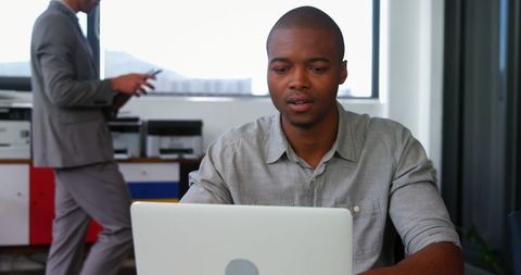 Focused Entrepreneur Working on Laptop in Modern Office - Download Free Stock Images Pikwizard.com